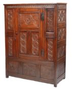 A Charles II oak livery cupboard, West Country, circa 1670 Having a triple-panelled central door,