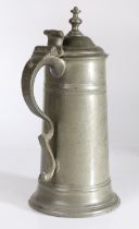 A George I/II pewter spire flagon, circa 1720-50 Having a straight-sided tapering drum with broad