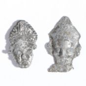 Two mid-14th century pewter pilgrim badges, the head of St. Thomas Becket, circa 1350 Both a