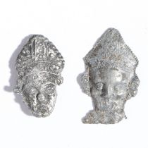 Two mid-14th century pewter pilgrim badges, the head of St. Thomas Becket, circa 1350 Both a
