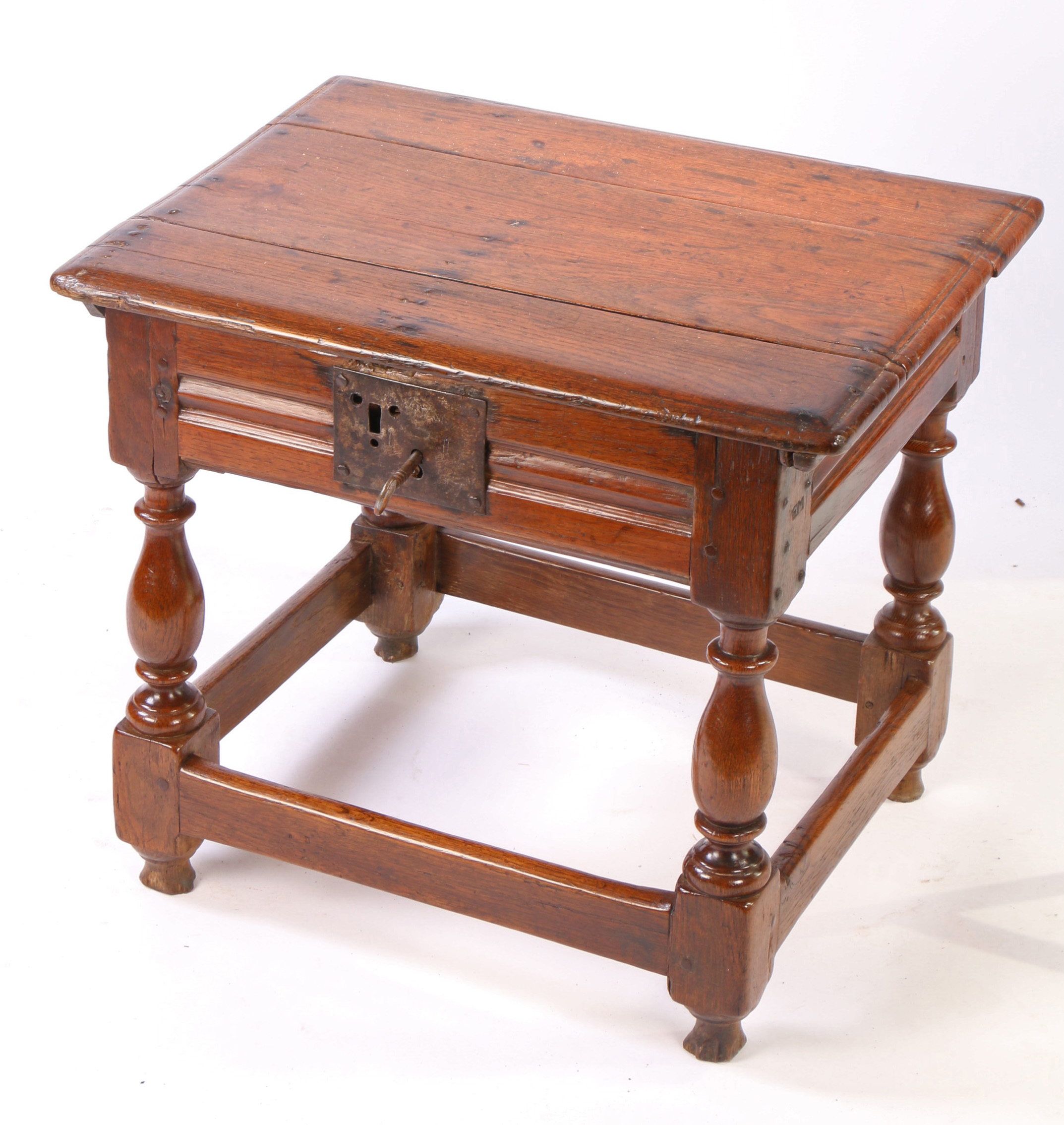 A comparatively large Charles II oak box-stool, circa 1660 Having a rectangular ovolo-moulded hinged