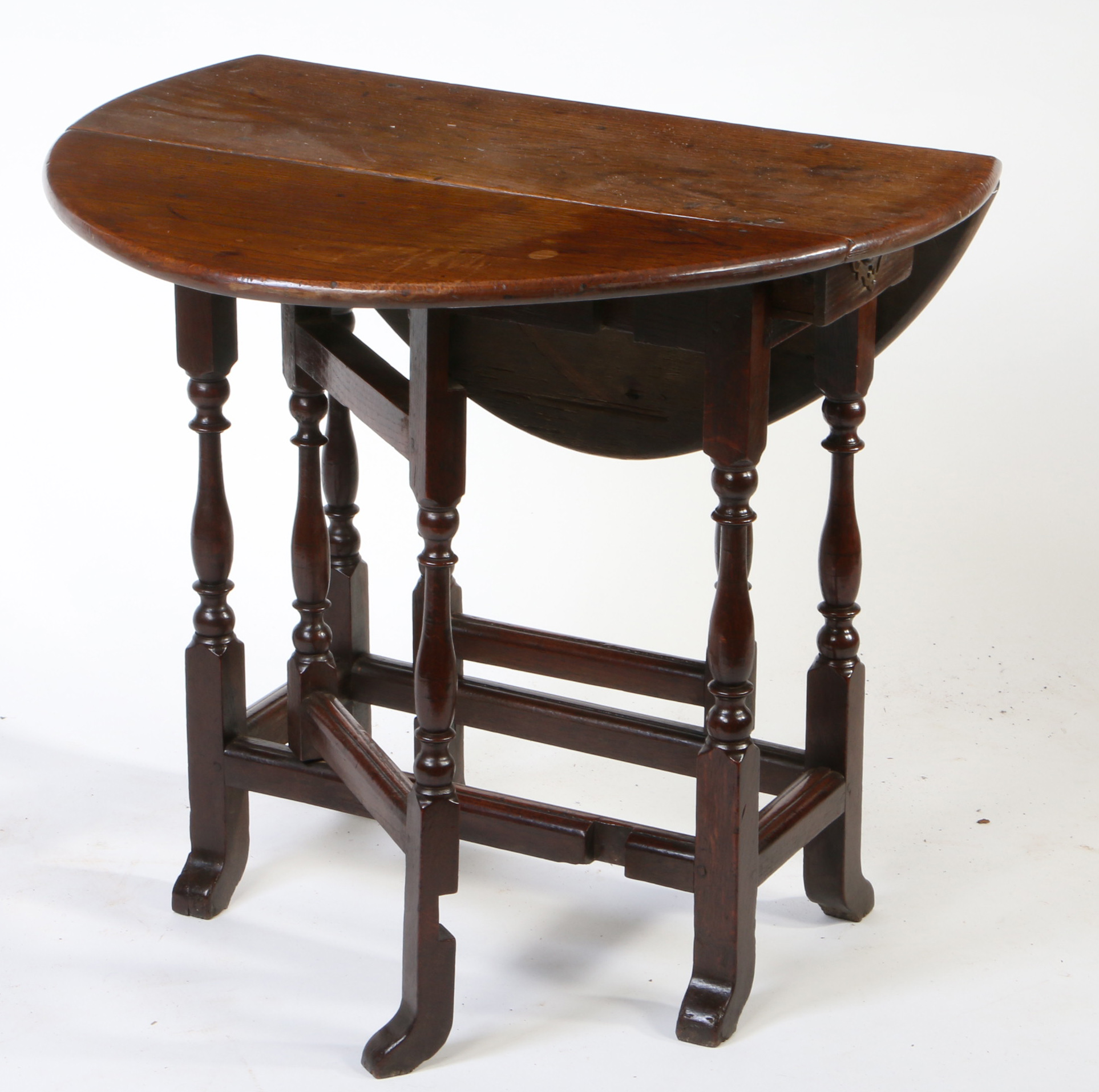 A William and Mary oak gateleg occasional table, circa 1690 Having an oval drop-leaf top, formed