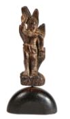 A naive carving of St. Sebastian Modelled standing tied to a tree, on a domed plinth, height 32.5cm