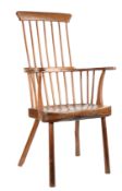 A George III ash comb-back primitive Windsor armchair, West Country, circa 1800 The tall back of