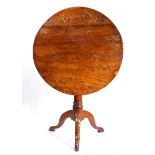 A George II solid yew tripod occasional table, circa 1750 Having a circular four-plank tilt-action
