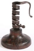 A late 18th century wrought iron and oak spiral candleholder, Anglo-French, circa 1770-1800 The