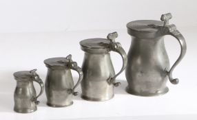 Four George III OEWS pewter double-volute baluster measures, circa 1770 A pint, with plain body,