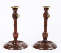 A pair of late George III rosewood and brass candlesticks, circa 1800 With adjustable height pillar,