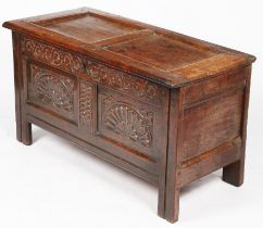 A Charles I oak coffer, West Country, circa 1640 Having a twin-panelled lid, the front again with