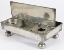 A George III pewter ‘treasury' inkstand, circa 1800 Of typical flat rectangular twin-flap form,