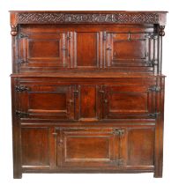 A Charles II oak court cupboard, dated 1674 The scroll carved frieze centred by the date '1674',