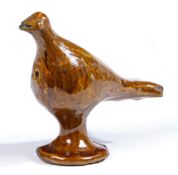 A pottery Halifax slipware whistle, circa 1800 Designed as a standing bird, 18cm long, 15cm high