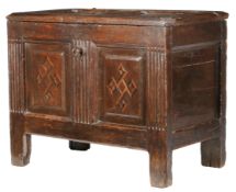 An early 17th century oak and inlaid coffer, circa 1610 The hinged lid with two fielded panels,