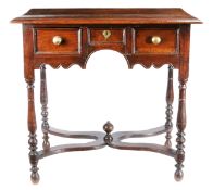 A William & Mary oak side or dressing table, circa 1690 Having a triple boarded and ovolo-moulded
