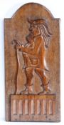 An unusual 18th century carved walnut figural panel, English Designed as a gentleman, wearing a