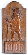 An unusual 18th century carved walnut figural panel, English Designed as a gentleman, wearing a