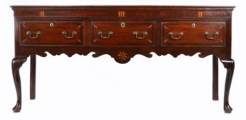 A George III oak and inlaid low dresser, North-West/West Midlands, circa 1780- The top of two wide