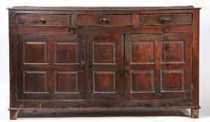 A George III oak fully-enclosed oak dresser base, circa 1760 The boarded top with shallow broad rear