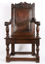A James I oak open armchair, West Country, circa 1625 The back panel with triple-reeded and