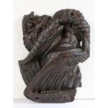 A rare 15th century oak dragon-carved boss, English, circa 1400 The snarling, winged beast clenching