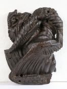 A rare 15th century oak dragon-carved boss, English, circa 1400 The snarling, winged beast clenching