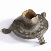 A 14th century pewter votive candlestick Having a short cylindrical socket, on a flat circular