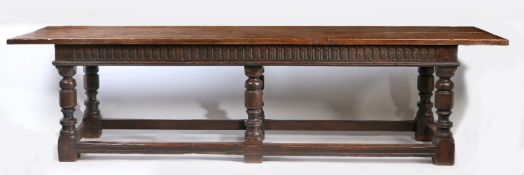 A large Charles II style refectory table The twin-plank top above a lunette-carved frieze, on six