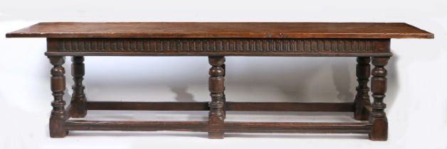 A large Charles II style refectory table The twin-plank top above a lunette-carved frieze, on six