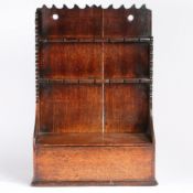 A George III oak spoon rack, circa 1800 The backboards with scroll-profiled flat cresting and