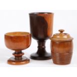 Three items of treen To include a lignum vitae goblet with turned baluster stem, 20.5cm high, a