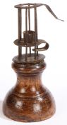 A very small mid to late 18th century wrought iron and fruitwood stable or birdcage candleholder,