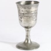 A George III pewter communion cup, circa 1800 The bowl with flared rim and central multiple-reeded