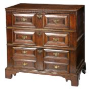 A Charles II oak chest of drawers, circa 1680 In two-parts, the top formed from two wide boards,