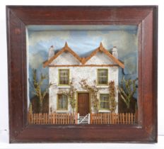 A Victorian cased diorama, depicting a house, circa 1870 The twin-gabled house with cork roof and ‘