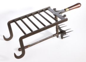 A fine George III iron bar grate lark-spit, circa 1790 The cooking prongs moving backwards and