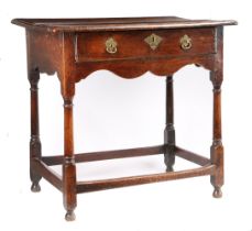 A small George I oak side table, circa 1720 The top of two boards with ovolo-moulded edge, single