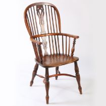 An early Victorian yew and elm high-back Windsor armchair, circa 1840 The hooped back with four long