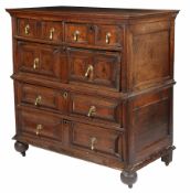 A large Charles II oak chest of drawers, circa 1680 Typically in two parts, having a triple