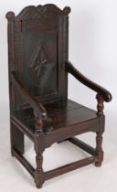 A Charles I oak open armchair, circa 1640 and later The back panel carved with a large flowerhead