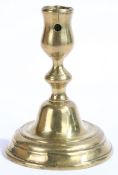An early 18th century brass candlestick, Dutch, circa 1720 Having a tulip-shaped socket, with