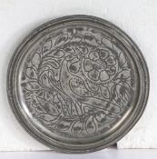 A good William & Mary pewter wrigglework narrow rim plate, circa 1700 The well designed central