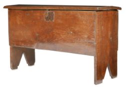 A 17th century oak boarded chest, English Having a one-piece lid with chip-carved ends, plain frieze