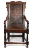 A Charles II oak open armchair, circa 1660 and later The back panel relief carved with strap-work