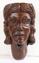 A 16th century carved oak head corbel, English Designed as a male with well-defined features, and