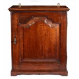 A George II oak table-top spice cupboard, circa 1750 and later Having a flattened-ogee arched