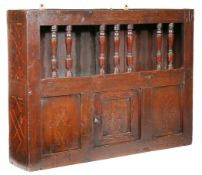 A Charles II oak and inlaid mural spindle livery cupboard, circa 1660 Having a row of seven turned