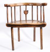 A George III primitive ash and elm comb-back Windsor armchair, Welsh, circa 1780 With horse-shoe