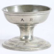 An early 19th century large pewter cup salt, English, circa 1800-40 With moulded lip, above the