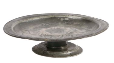 A rare Charles II pewter wrigglework footed plate or tazza, circa 1685 The plate with narrow