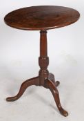 A George III oak tripod occasional table, circa 1780 Having a tilt-action, oval, one-piece top, a